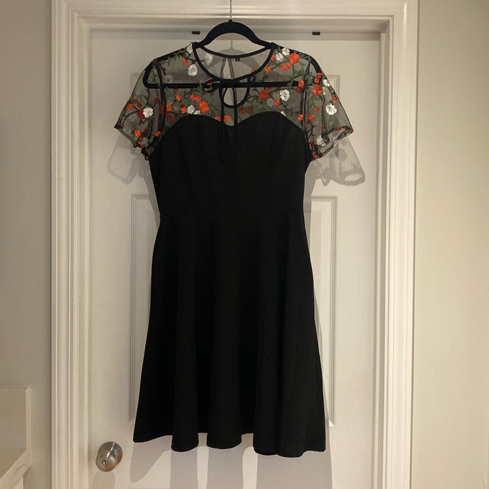 Black cocktail dress with sheer bodice.